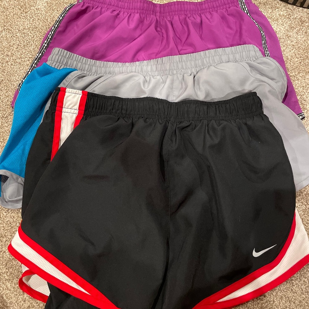 Three pairs of medium athletic shorts, Nike and Under Armour